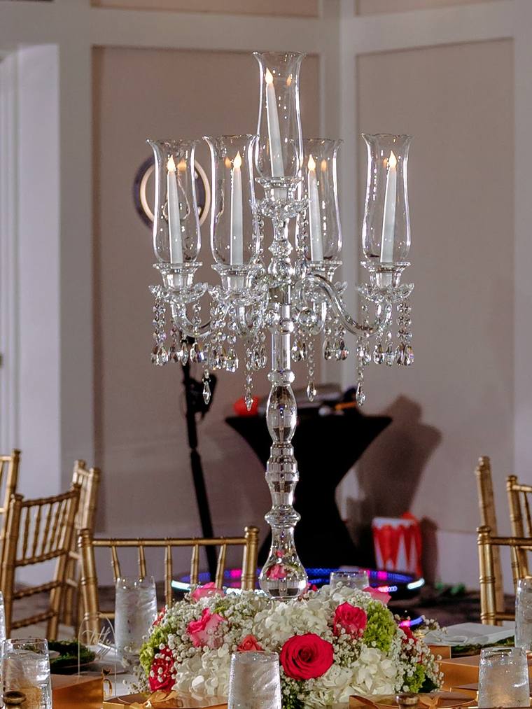 Close view of a 36-inch crystal candelabra with four arms, a center light, hurricane glass chimneys, and hanging crystal drops